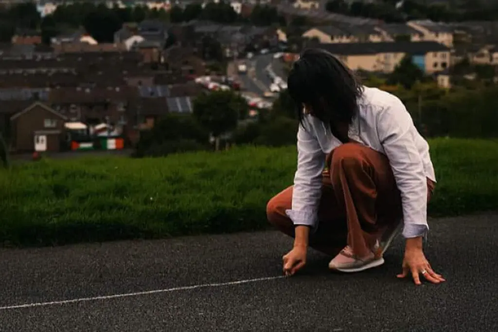 Sinéad Smyth drawing a chalk line around the city of Derry